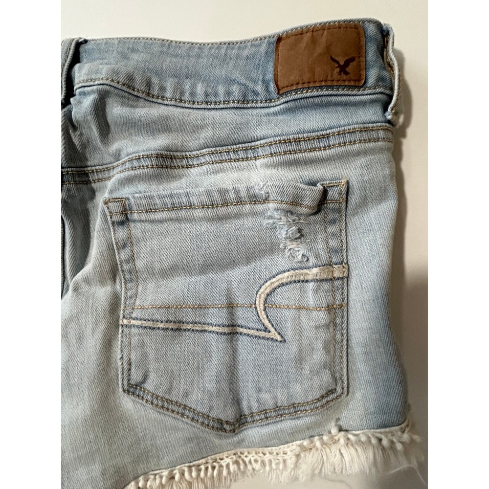 American Eagle Shortie Distressed Denim Shorts Light Wash Pom Pom Trim Cut Off 6